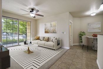 A living room with a white couch and a rug with a black and white pattern.